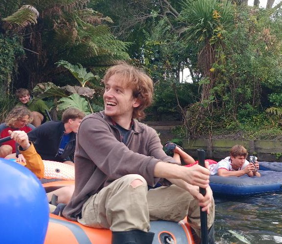 gareth sitting on the edge of an inflatable boat